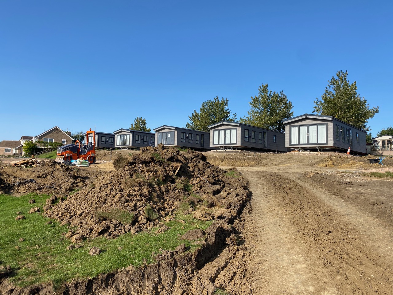 Groundworks and a new access track in front of a row of lodges